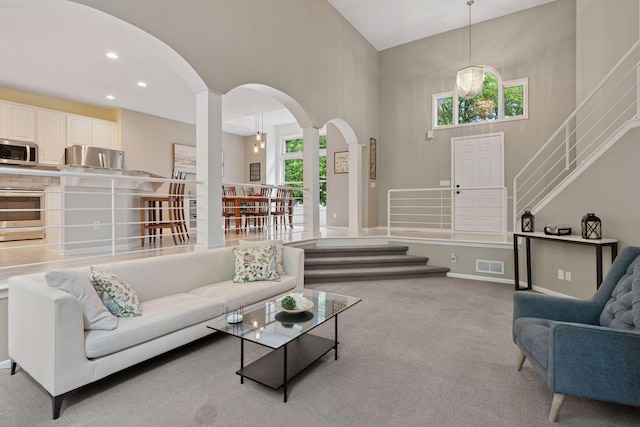 6609 Red Birch Ct, Lino Lakes, MN 55014 - living area with a high ceiling, arched walkways, stairway, and carpet floors