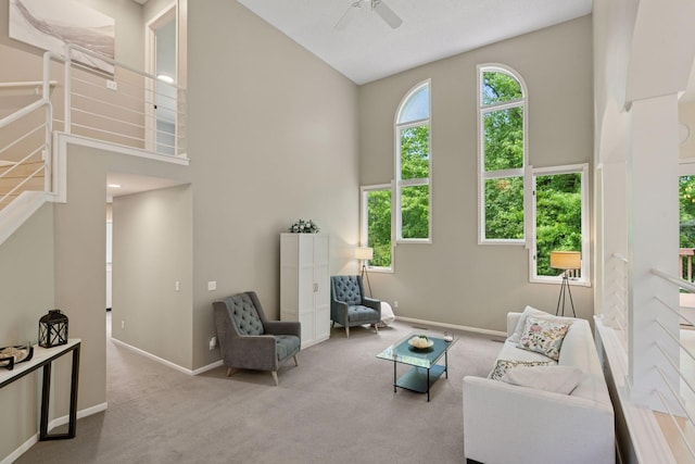6609 Red Birch Ct, Lino Lakes, MN 55014 - living area with carpet floors, baseboards, ceiling fan, a high ceiling, and stairs