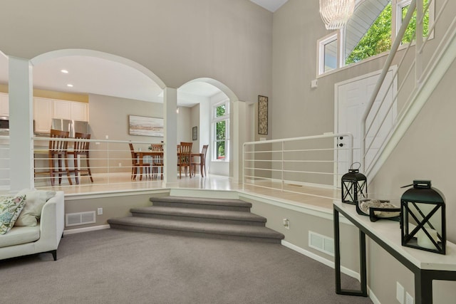 6609 Red Birch Ct, Lino Lakes, MN 55014 - staircase featuring arched walkways, carpet flooring, baseboards, and recessed lighting