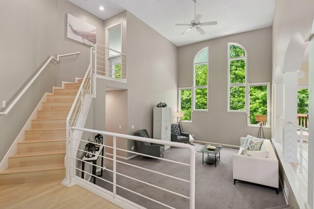 6609 Red Birch Ct, Lino Lakes, MN 55014 - living room with a towering ceiling, ceiling fan, stairway, and baseboards