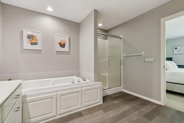 6609 Red Birch Ct, Lino Lakes, MN 55014 - bathroom featuring connected bathroom, a garden tub, a stall shower, recessed lighting, and wood finished floors