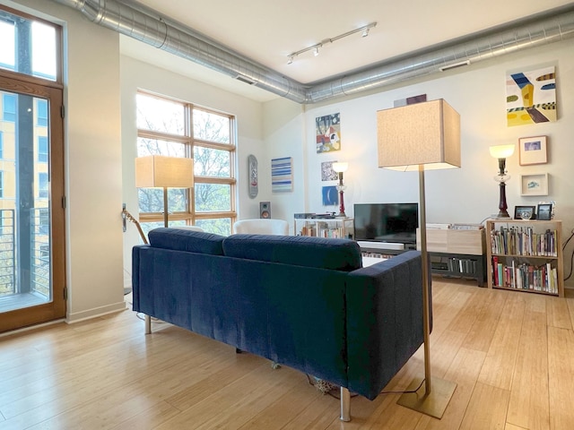 2840 Bryant Ave S Unit E303, Minneapolis, MN 55408 - living area with track lighting, light wood-style flooring, and plenty of natural light