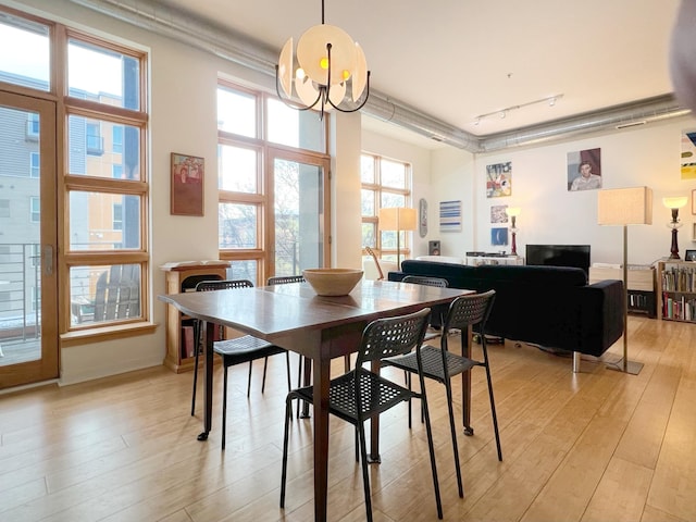 2840 Bryant Ave S Unit E303, Minneapolis, MN 55408 - dining area with light wood-style floors, rail lighting, and crown molding