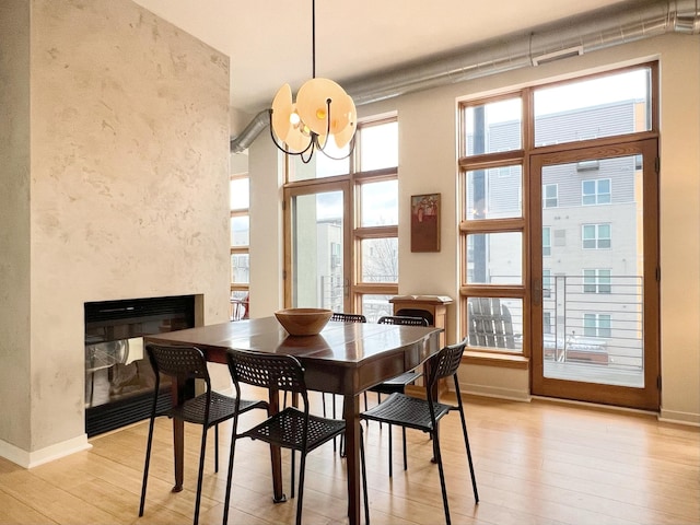 2840 Bryant Ave S Unit E303, Minneapolis, MN 55408 - dining space with a high end fireplace, light wood finished floors, and healthy amount of natural light