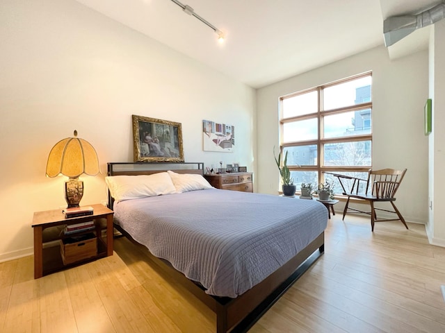 2840 Bryant Ave S Unit E303, Minneapolis, MN 55408 - bedroom featuring track lighting, light wood-type flooring, and baseboards