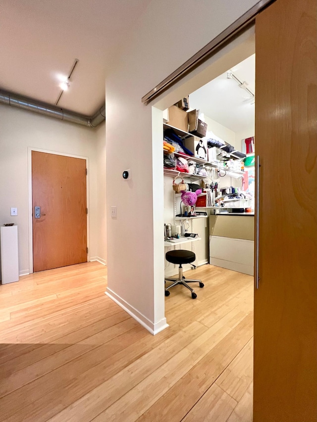 2840 Bryant Ave S Unit E303, Minneapolis, MN 55408 - hall with an office area, wood finished floors, and rail lighting