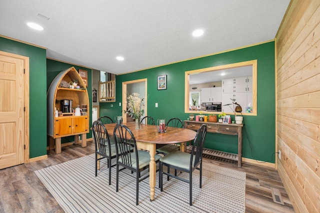 3108 4th Ave, Grand Rapids, MN 55744 - dining area featuring wooden walls, recessed lighting, baseboards, and wood finished floors