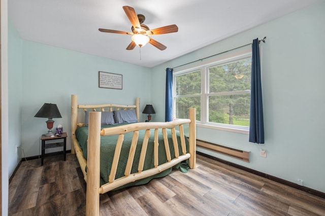 3108 4th Ave, Grand Rapids, MN 55744 - bedroom with a baseboard radiator, wood finished floors, and baseboards