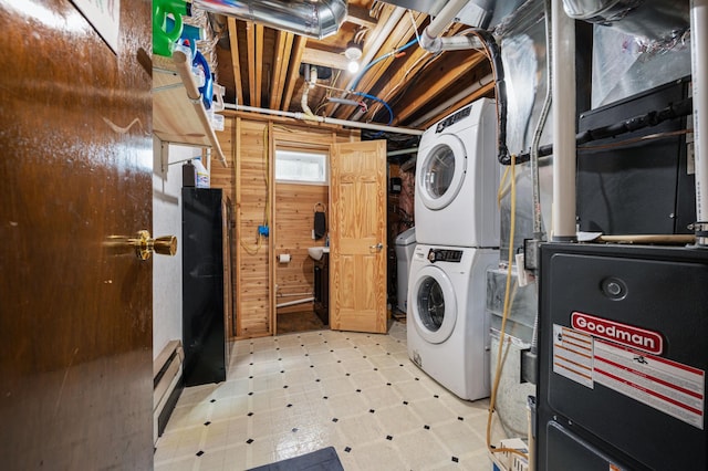 3108 4th Ave, Grand Rapids, MN 55744 - washroom with stacked washing machine and dryer, light floors, and wood walls