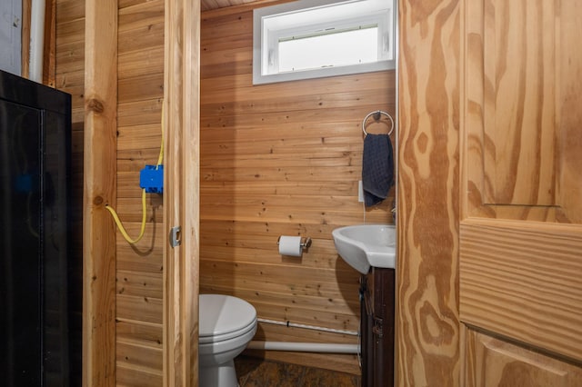 3108 4th Ave, Grand Rapids, MN 55744 - half bath with toilet, wooden walls, and vanity