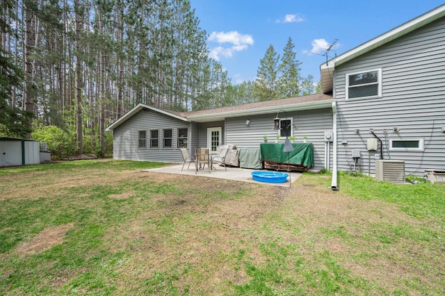 3108 4th Ave, Grand Rapids, MN 55744 - back of property featuring a patio, a lawn, and central AC unit
