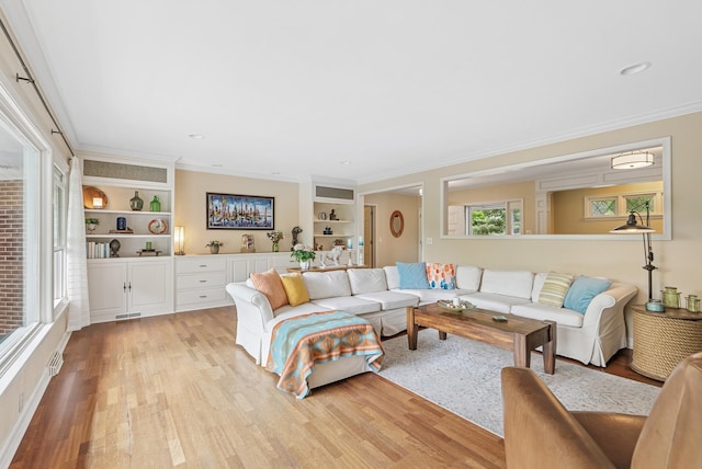 6413 Mendelssohn Ln, Edina, MN 55343 - living area with light wood-style flooring, ornamental molding, and built in shelves