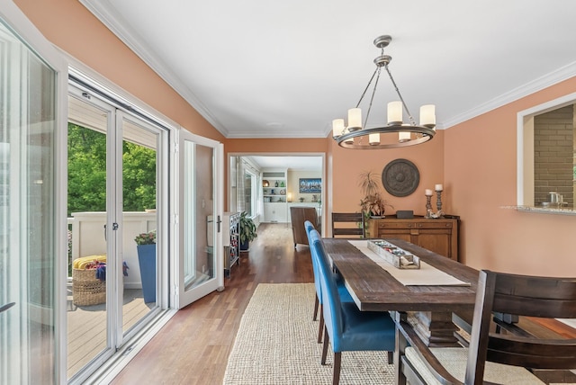 6413 Mendelssohn Ln, Edina, MN 55343 - dining space featuring a chandelier, wood finished floors, and crown molding