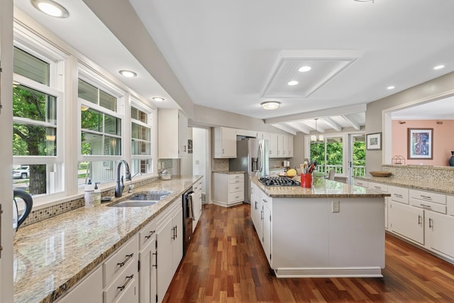 6413 Mendelssohn Ln, Edina, MN 55343 - kitchen featuring a sink, stainless steel appliances, white cabinetry, a center island, and decorative backsplash