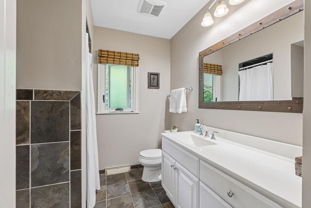 6413 Mendelssohn Ln, Edina, MN 55343 - full bathroom featuring vanity, toilet, a baseboard heating unit, baseboards, and a shower with shower curtain
