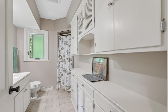 6413 Mendelssohn Ln, Edina, MN 55343 - bathroom featuring toilet, vanity, tile patterned flooring, curtained shower, and baseboards