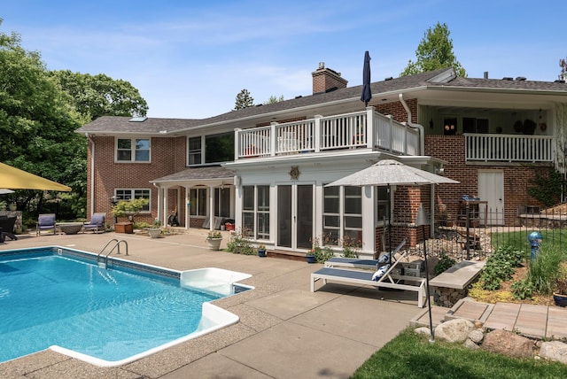 6413 Mendelssohn Ln, Edina, MN 55343 - rear view of house featuring a balcony, a patio, brick siding, a chimney, and french doors