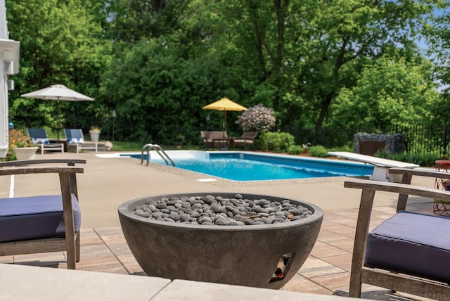 6413 Mendelssohn Ln, Edina, MN 55343 - swimming pool featuring a patio, a diving board, a fire pit, and view of wooded area