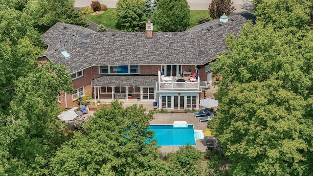 6413 Mendelssohn Ln, Edina, MN 55343 - back of house featuring a balcony, a chimney, a patio area, and an outdoor pool