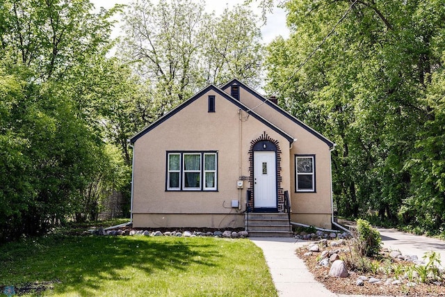 1342 10th St N, Fargo, ND 58102 - view of front of house with a front yard, stucco siding, and entry steps