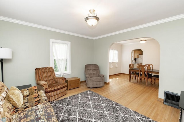 1342 10th St N, Fargo, ND 58102 - living area featuring arched walkways, ornamental molding, wood finished floors, and baseboards
