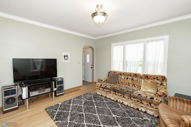 1342 10th St N, Fargo, ND 58102 - living room with arched walkways, crown molding, wood finished floors, and baseboards