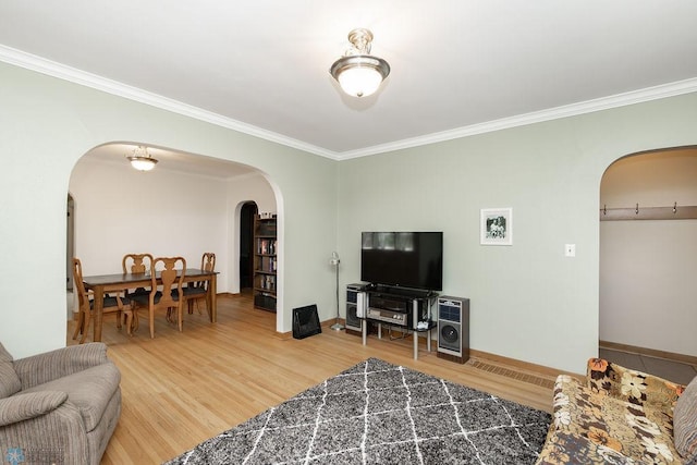 1342 10th St N, Fargo, ND 58102 - living area featuring arched walkways, light wood finished floors, ornamental molding, and baseboards