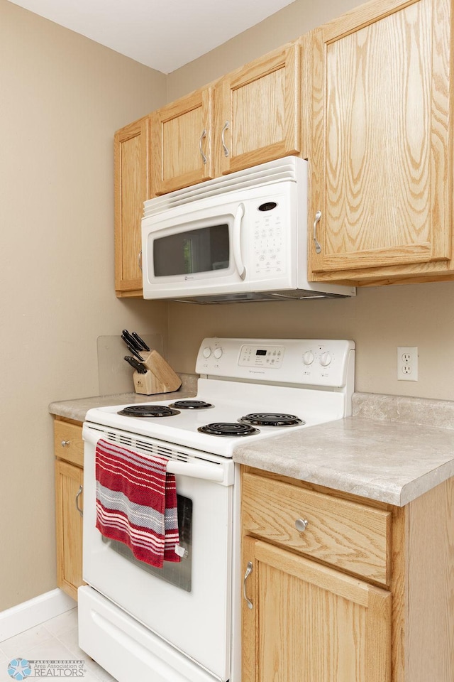 1342 10th St N, Fargo, ND 58102 - kitchen featuring white appliances, light brown cabinetry, light countertops, and light tile patterned floors