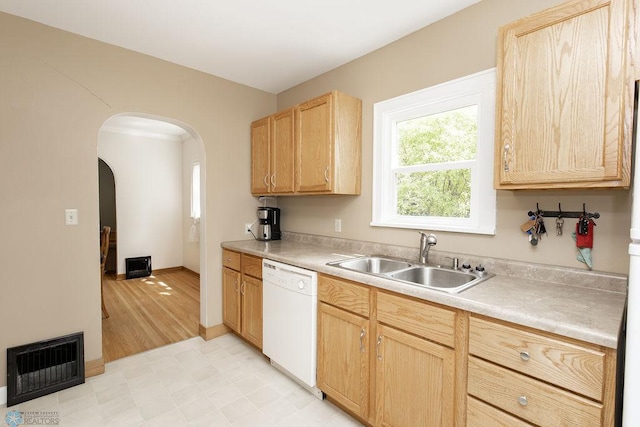1342 10th St N, Fargo, ND 58102 - kitchen with white dishwasher, a sink, light brown cabinets, arched walkways, and light countertops