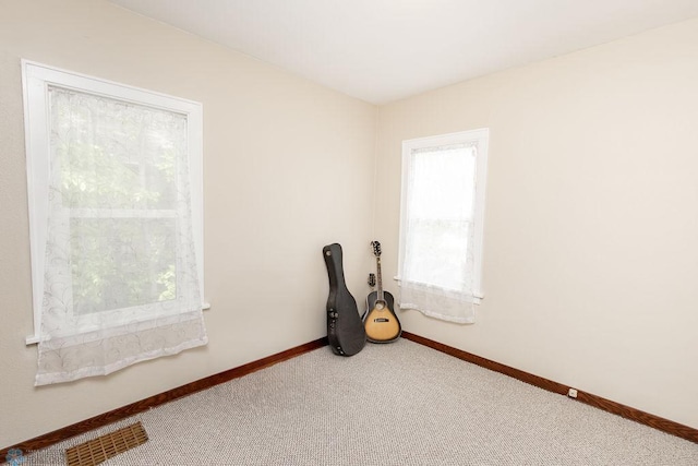 1342 10th St N, Fargo, ND 58102 - empty room with carpet flooring and baseboards