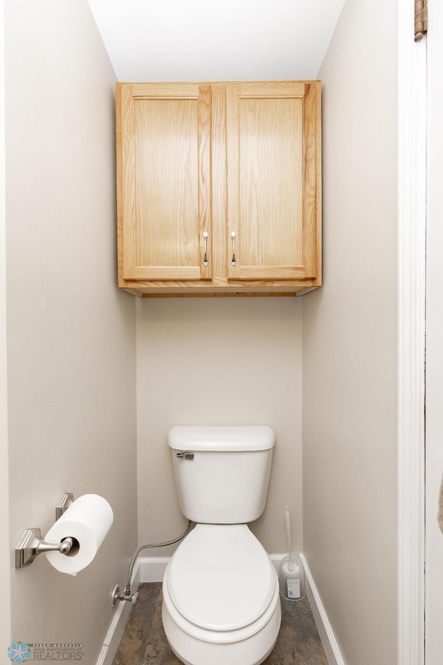 1342 10th St N, Fargo, ND 58102 - bathroom featuring baseboards and toilet