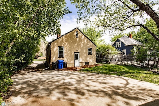 1342 10th St N, Fargo, ND 58102 - rear view of house with stucco siding and a chimney