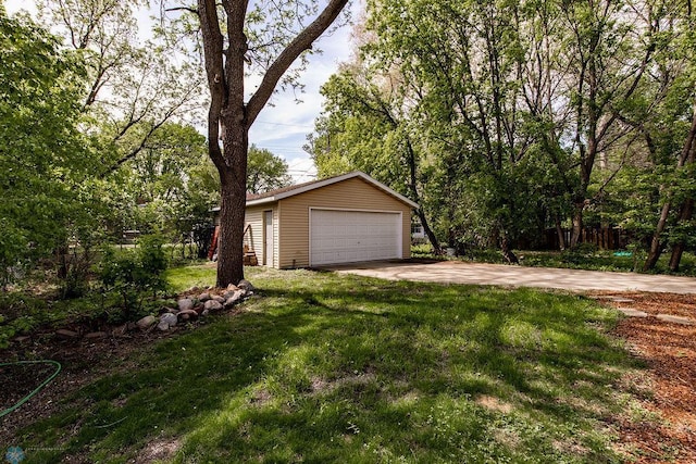 1342 10th St N, Fargo, ND 58102 - view of grassy yard with an outdoor structure and a detached garage