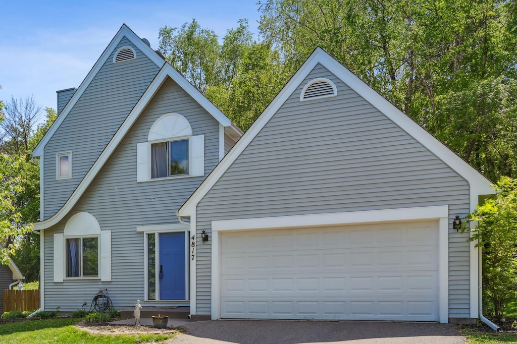 4817 144th St, Savage, MN 55378 - view of front of home featuring an attached garage and driveway