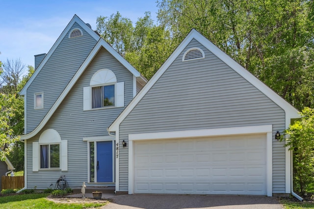4817 144th St, Savage, MN 55378 - view of front of home featuring an attached garage and driveway