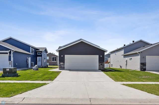 6718 69th Ave S, Horace, ND 58047 - view of front of house featuring a front yard, a garage, and stone siding