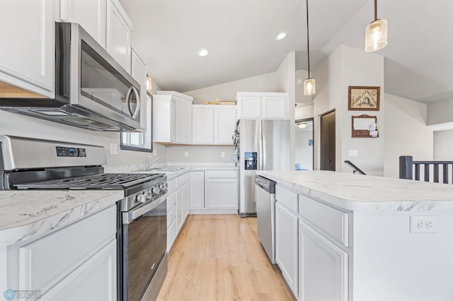 6718 69th Ave S, Horace, ND 58047 - kitchen with appliances with stainless steel finishes, a sink, light wood-style floors, vaulted ceiling, and white cabinets