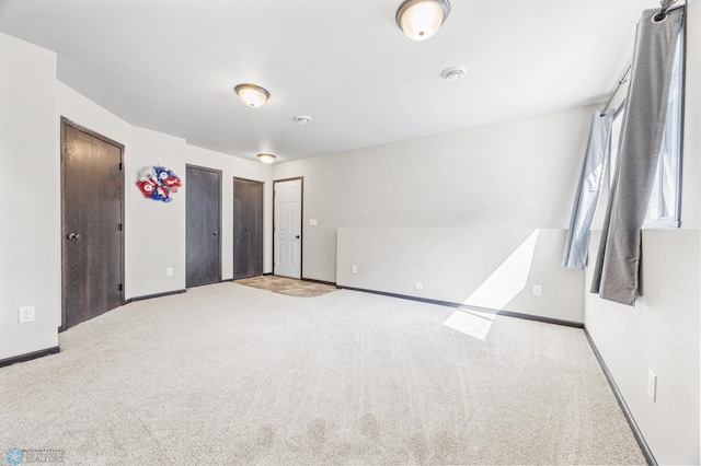 6718 69th Ave S, Horace, ND 58047 - unfurnished bedroom featuring carpet flooring, baseboards, and multiple closets