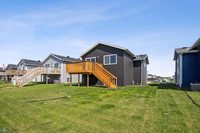 6718 69th Ave S, Horace, ND 58047 - back of house featuring stairs, a deck, central AC, and a lawn