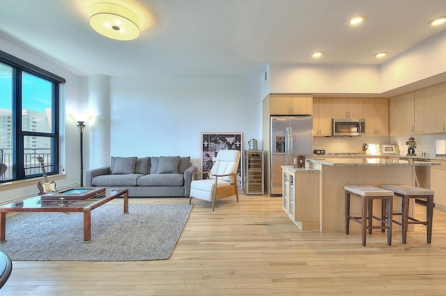 740 Portland Ave Unit 1005, Minneapolis, MN 55415 - living room featuring wine cooler, light wood-type flooring, healthy amount of natural light, and recessed lighting