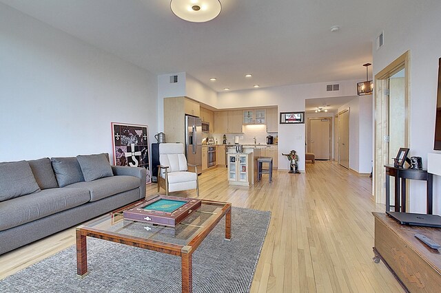 740 Portland Ave Unit 1005, Minneapolis, MN 55415 - living area featuring light wood finished floors and recessed lighting
