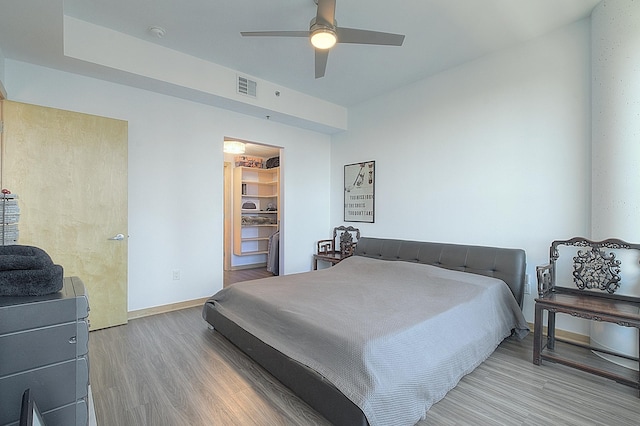 740 Portland Ave Unit 1005, Minneapolis, MN 55415 - bedroom featuring wood finished floors, baseboards, ceiling fan, and a spacious closet