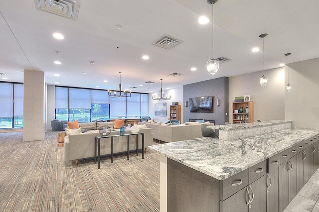 740 Portland Ave Unit 1005, Minneapolis, MN 55415 - kitchen featuring light colored carpet, a chandelier, a wall of windows, recessed lighting, and open floor plan