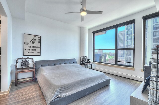 740 Portland Ave Unit 1005, Minneapolis, MN 55415 - bedroom featuring wood finished floors, a baseboard heating unit, and ceiling fan