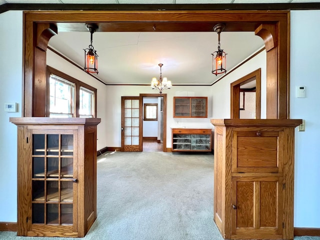 508 2nd Ave, Goodhue, MN 55027 - living area featuring carpet, baseboards, crown molding, and a chandelier