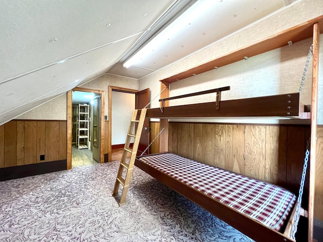 508 2nd Ave, Goodhue, MN 55027 - bedroom featuring wooden walls, vaulted ceiling, and carpet
