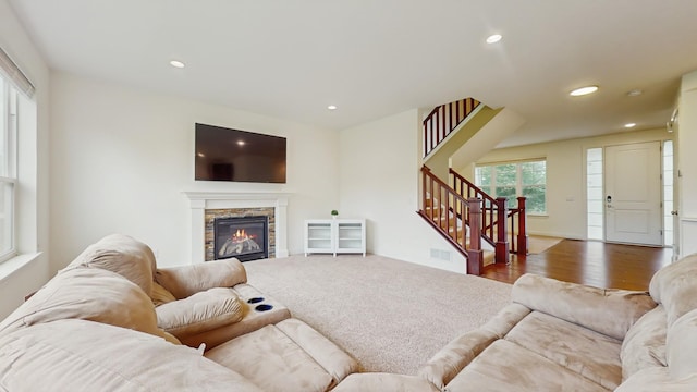 11330 Harness Rd, Woodbury, MN 55129 - living room with stairway, recessed lighting, a fireplace, and wood finished floors