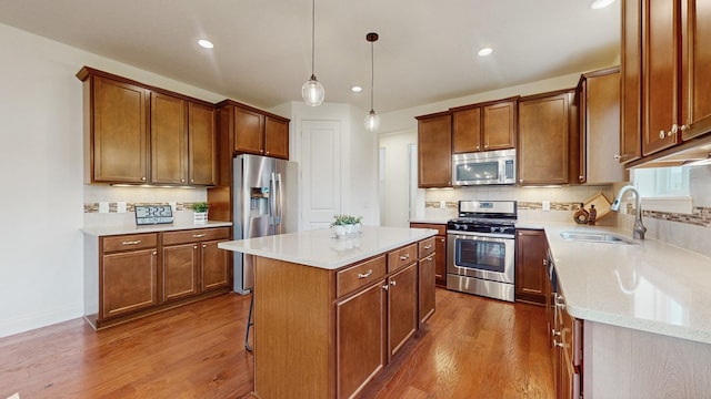 11330 Harness Rd, Woodbury, MN 55129 - kitchen with appliances with stainless steel finishes, a sink, dark wood-style floors, backsplash, and a center island