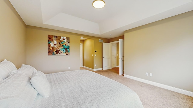 11330 Harness Rd, Woodbury, MN 55129 - bedroom featuring light carpet, a raised ceiling, and baseboards