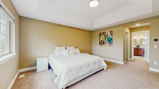 11330 Harness Rd, Woodbury, MN 55129 - bedroom with a tray ceiling, light carpet, and baseboards